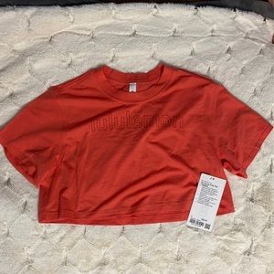 NWT lululemon all yours crop graphic tee, color is warm coral, size 2